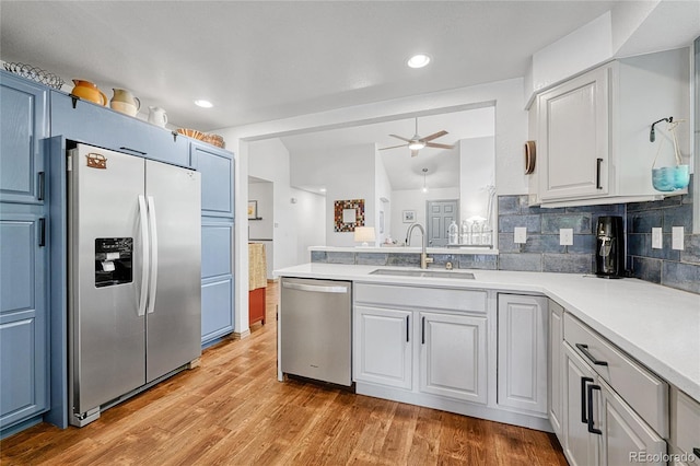 11820 W 66th Pl Unit C, Arvada, CO 80004 - kitchen featuring stainless steel appliances, a sink, ceiling fan, light countertops, and light wood-style flooring
