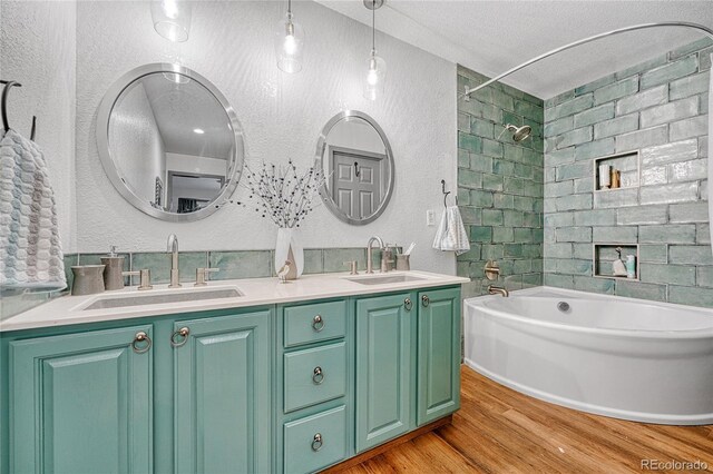 11820 W 66th Pl Unit C, Arvada, CO 80004 - bathroom with a textured wall, wood finished floors, double vanity, shower / washtub combination, and a textured ceiling