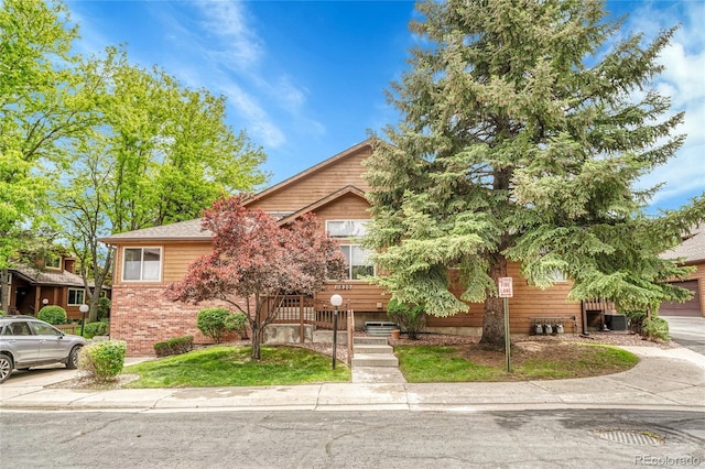 11820 W 66th Pl Unit C, Arvada, CO 80004 - view of property hidden behind natural elements featuring brick siding