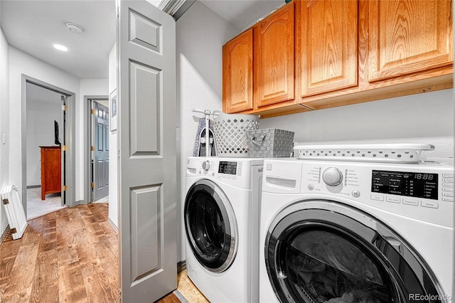 11820 W 66th Pl Unit C, Arvada, CO 80004 - laundry room with washer and dryer, cabinet space, and light wood-style flooring