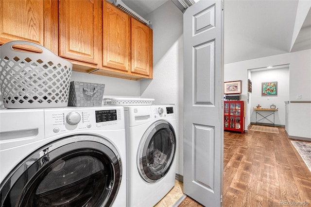 11820 W 66th Pl Unit C, Arvada, CO 80004 - washroom featuring washer and dryer, cabinet space, and light wood-style floors