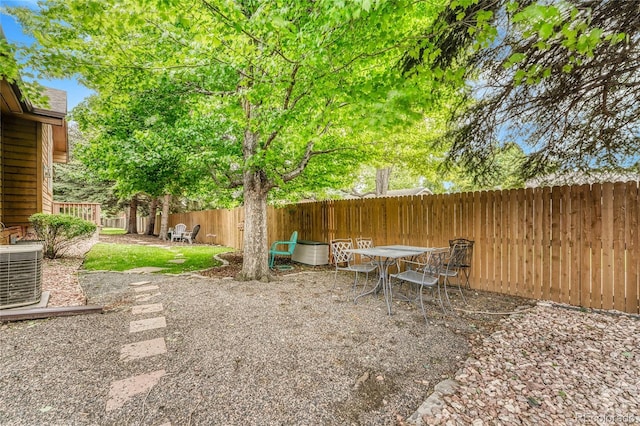11820 W 66th Pl Unit C, Arvada, CO 80004 - fenced backyard featuring central air condition unit, a patio area, and outdoor dining area