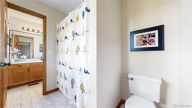 10346 E Crestridge Ln, Englewood, CO 80111 - bathroom with vanity, toilet, tile patterned flooring, a shower with curtain, and baseboards