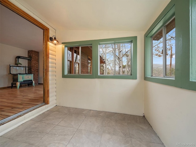 unfurnished sunroom featuring lofted ceiling