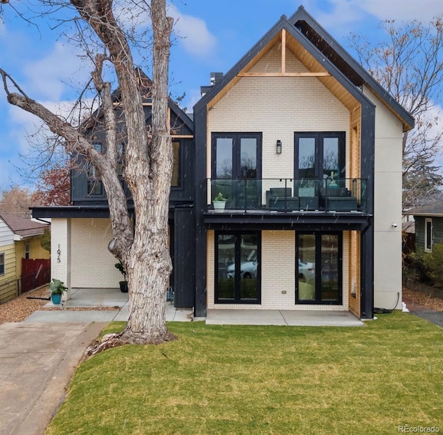 1675 S Steele St, Denver, CO 80210 - back of property with french doors, a balcony, brick siding, and a yard