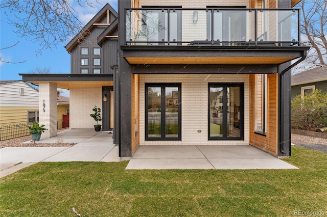 1675 S Steele St, Denver, CO 80210 - rear view of house featuring a balcony, brick siding, and a patio