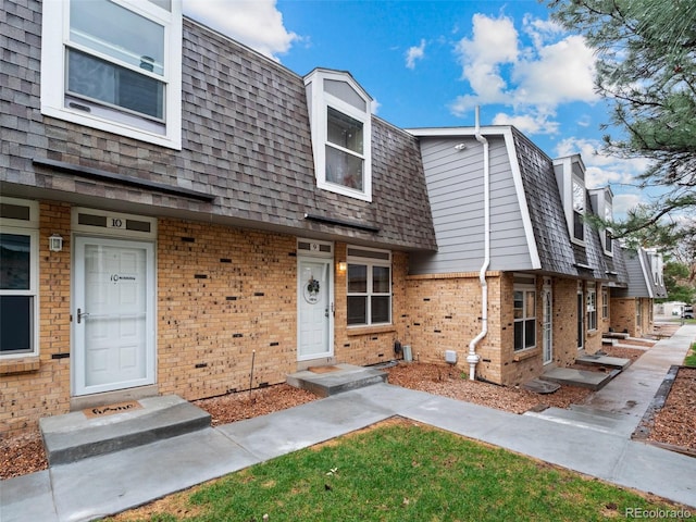 1517 S Owens St Unit 9, Denver, CO 80232 - view of property with brick siding, roof with shingles, and mansard roof