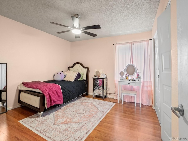 1517 S Owens St Unit 9, Denver, CO 80232 - bedroom featuring a ceiling fan, baseboards, a textured ceiling, and wood finished floors