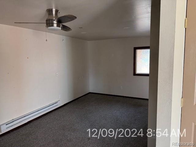 spare room with ceiling fan, carpet, and a baseboard heating unit