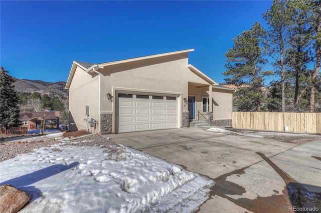 view of front of property featuring a garage and a mountain view