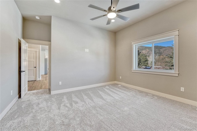 unfurnished room with light carpet and ceiling fan