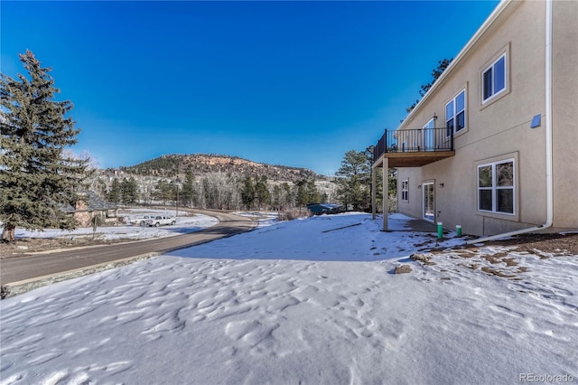 snowy yard with a mountain view