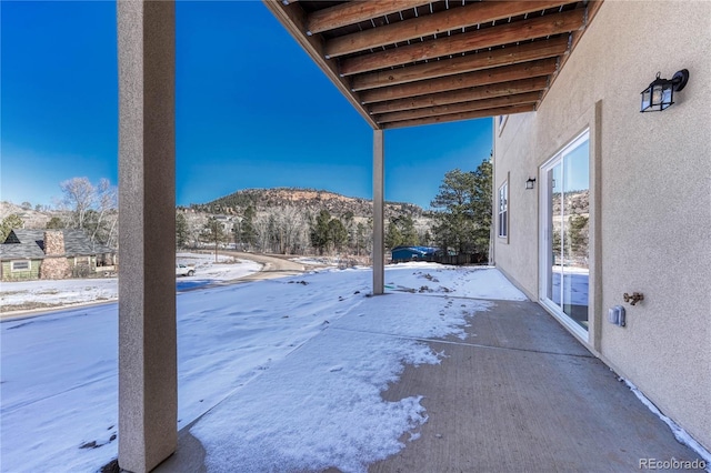 snowy yard featuring a mountain view