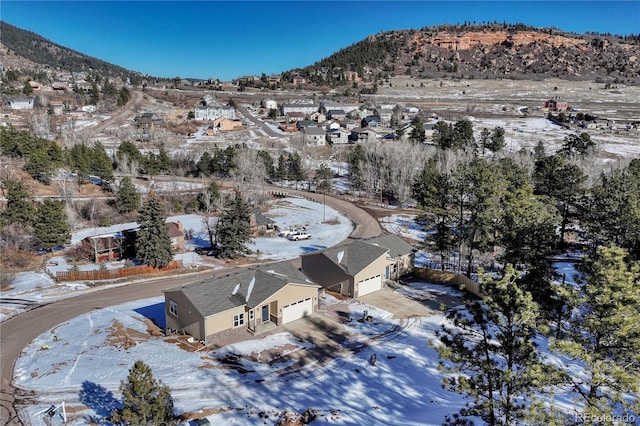 snowy aerial view featuring a mountain view