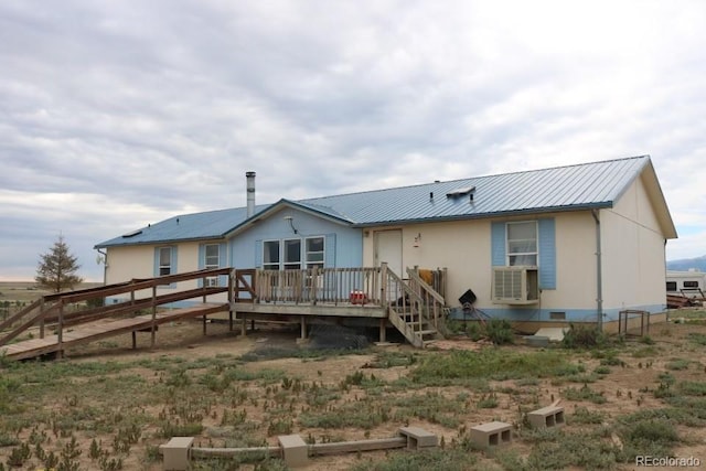 rear view of property with a wooden deck