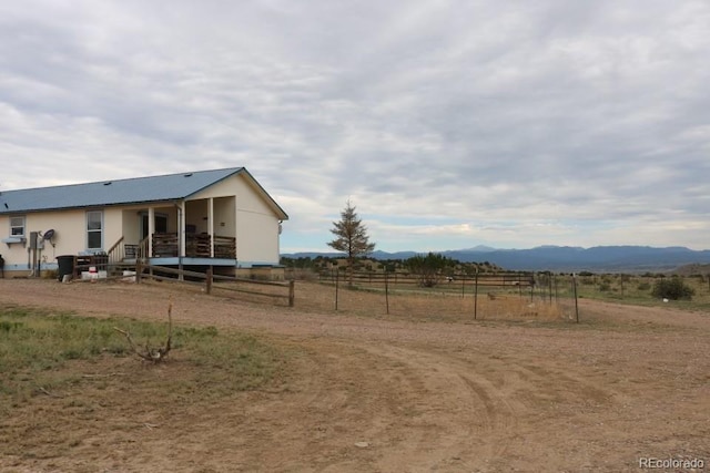 view of yard featuring a mountain view and a rural view