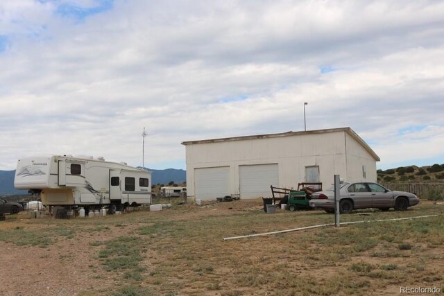 view of outbuilding with a garage and a mountain view