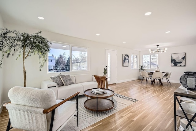 living room featuring light hardwood / wood-style flooring and a notable chandelier