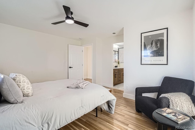 bedroom featuring ceiling fan, ensuite bathroom, and wood-type flooring