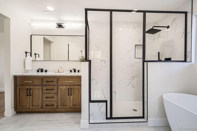 bathroom with a textured ceiling, independent shower and bath, and vanity