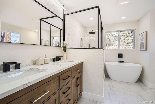 bathroom with vanity and separate shower and tub