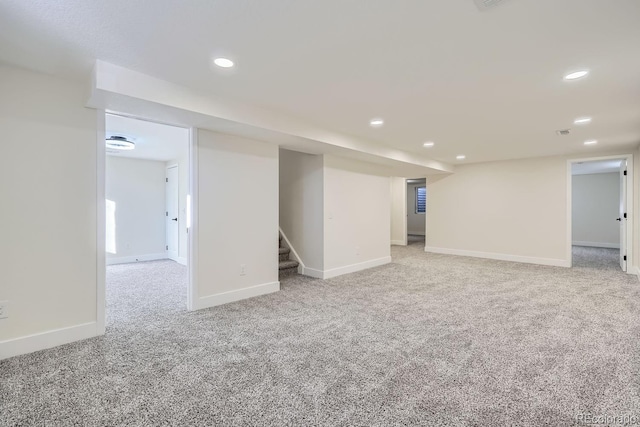 basement featuring light carpet