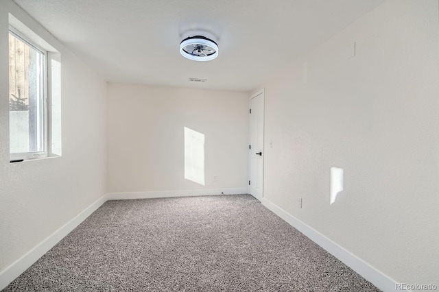 carpeted empty room with plenty of natural light