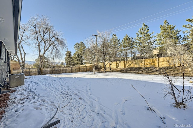 yard layered in snow featuring central AC