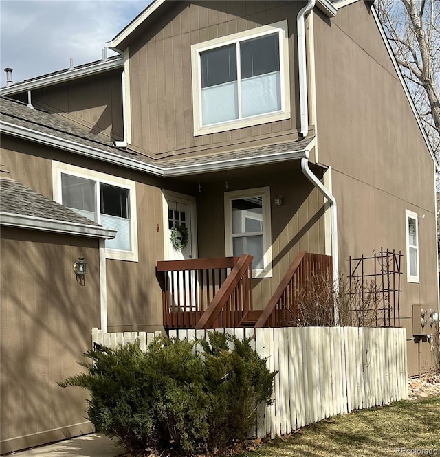 exterior space with covered porch and roof with shingles