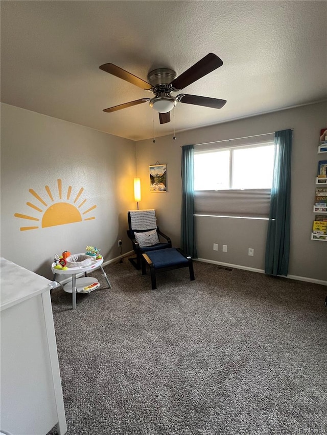 carpeted bedroom with a ceiling fan, visible vents, a textured ceiling, and baseboards