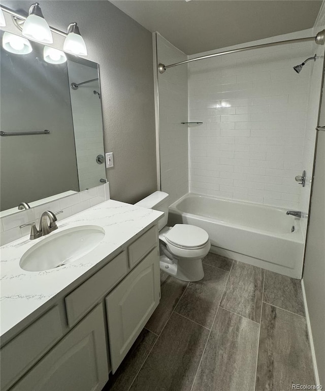 bathroom featuring a textured wall, toilet, wood tiled floor, tub / shower combination, and vanity