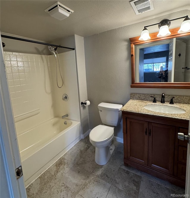 bathroom featuring toilet, a textured wall, vanity, and visible vents