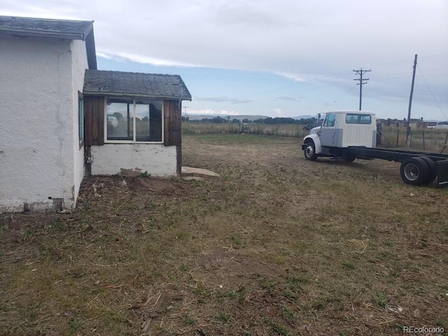 view of yard with a rural view