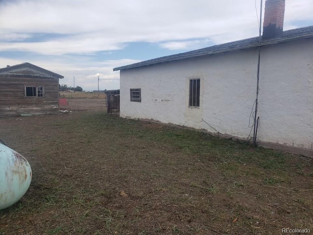 view of property exterior with a lawn and stucco siding