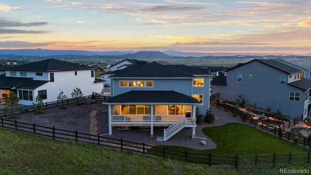 423 Rogers Way, Castle Rock, CO 80104 - rear view of house with stairway, a fenced backyard, a deck with mountain view, and a shingled roof
