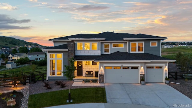 423 Rogers Way, Castle Rock, CO 80104 - view of front facade with driveway, an attached garage, and stone siding