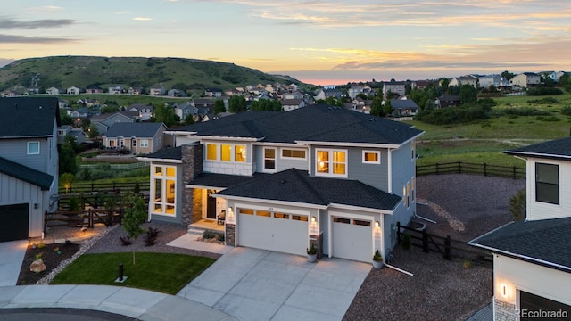 423 Rogers Way, Castle Rock, CO 80104 - view of front of house featuring driveway, a residential view, a mountain view, and stone siding