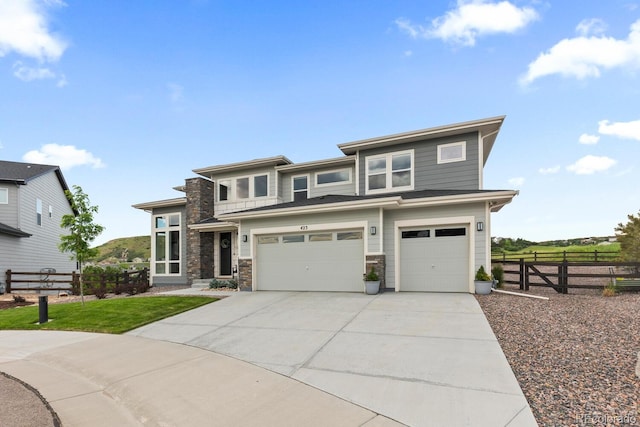423 Rogers Way, Castle Rock, CO 80104 - prairie-style home featuring an attached garage, concrete driveway, and stone siding