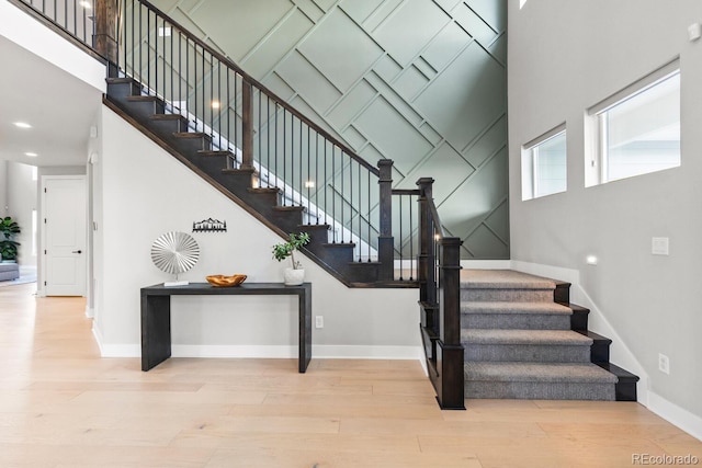 423 Rogers Way, Castle Rock, CO 80104 - stairs featuring a towering ceiling, wood finished floors, and recessed lighting