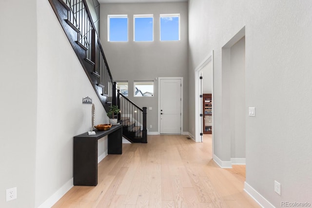 423 Rogers Way, Castle Rock, CO 80104 - foyer entrance featuring wood finished floors, stairs, and a high ceiling