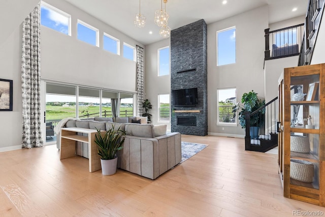 423 Rogers Way, Castle Rock, CO 80104 - living area featuring a high ceiling, stairway, plenty of natural light, light wood-type flooring, and recessed lighting