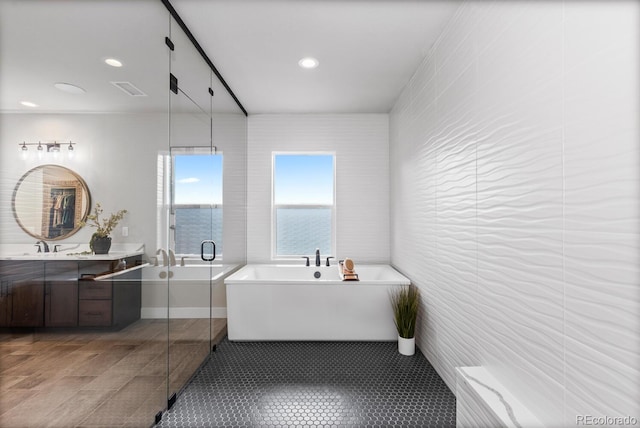 423 Rogers Way, Castle Rock, CO 80104 - bathroom featuring a soaking tub, vanity, a shower stall, recessed lighting, and tile patterned floors