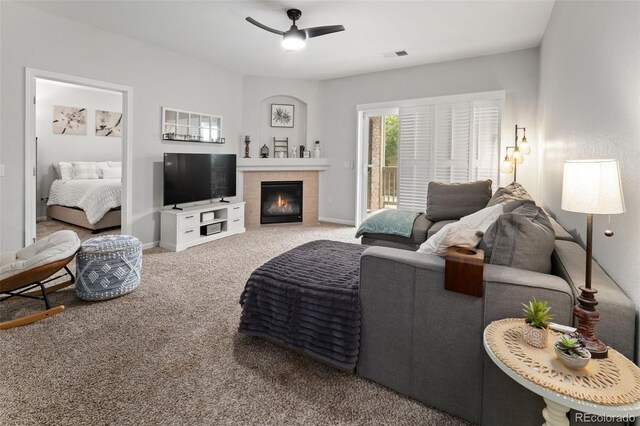 23346 E 5th Pl Unit 101, Aurora, CO 80018 - living area featuring carpet flooring, ceiling fan, a tiled fireplace, and baseboards