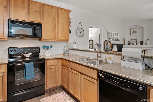 23346 E 5th Pl Unit 101, Aurora, CO 80018 - kitchen with black appliances, a sink, light wood-type flooring, and light countertops