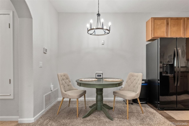 23346 E 5th Pl Unit 101, Aurora, CO 80018 - dining space with a chandelier, arched walkways, and baseboards