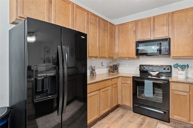 23346 E 5th Pl Unit 101, Aurora, CO 80018 - kitchen with black appliances, light countertops, light wood-style floors, and light brown cabinetry