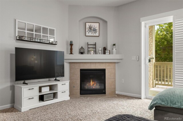 23346 E 5th Pl Unit 101, Aurora, CO 80018 - living area featuring carpet floors, baseboards, and a tiled fireplace