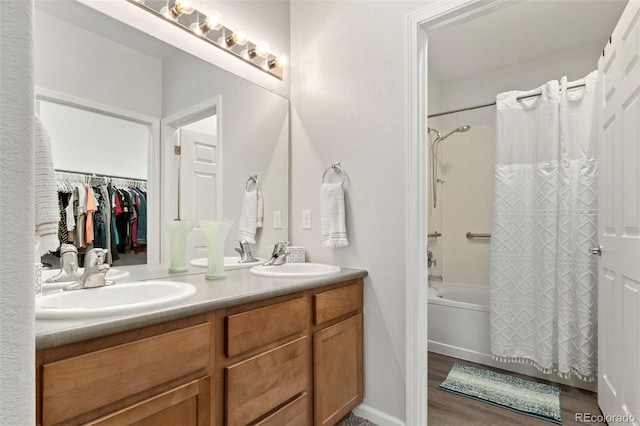 23346 E 5th Pl Unit 101, Aurora, CO 80018 - bathroom featuring shower / tub combo with curtain, double vanity, and wood finished floors