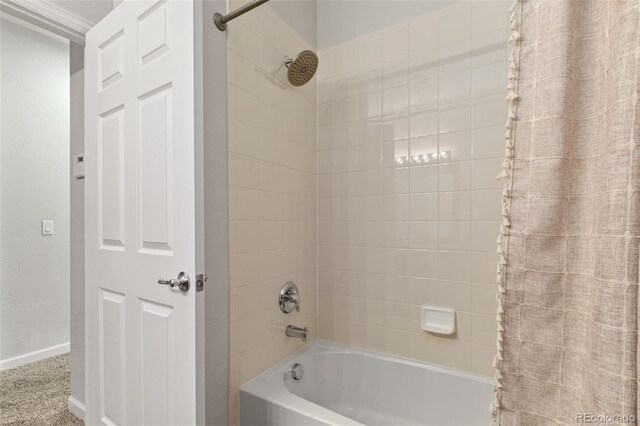 23346 E 5th Pl Unit 101, Aurora, CO 80018 - full bathroom featuring shower / tub combo with curtain and baseboards