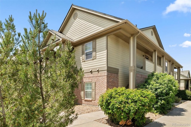 23346 E 5th Pl Unit 101, Aurora, CO 80018 - view of side of home with brick siding